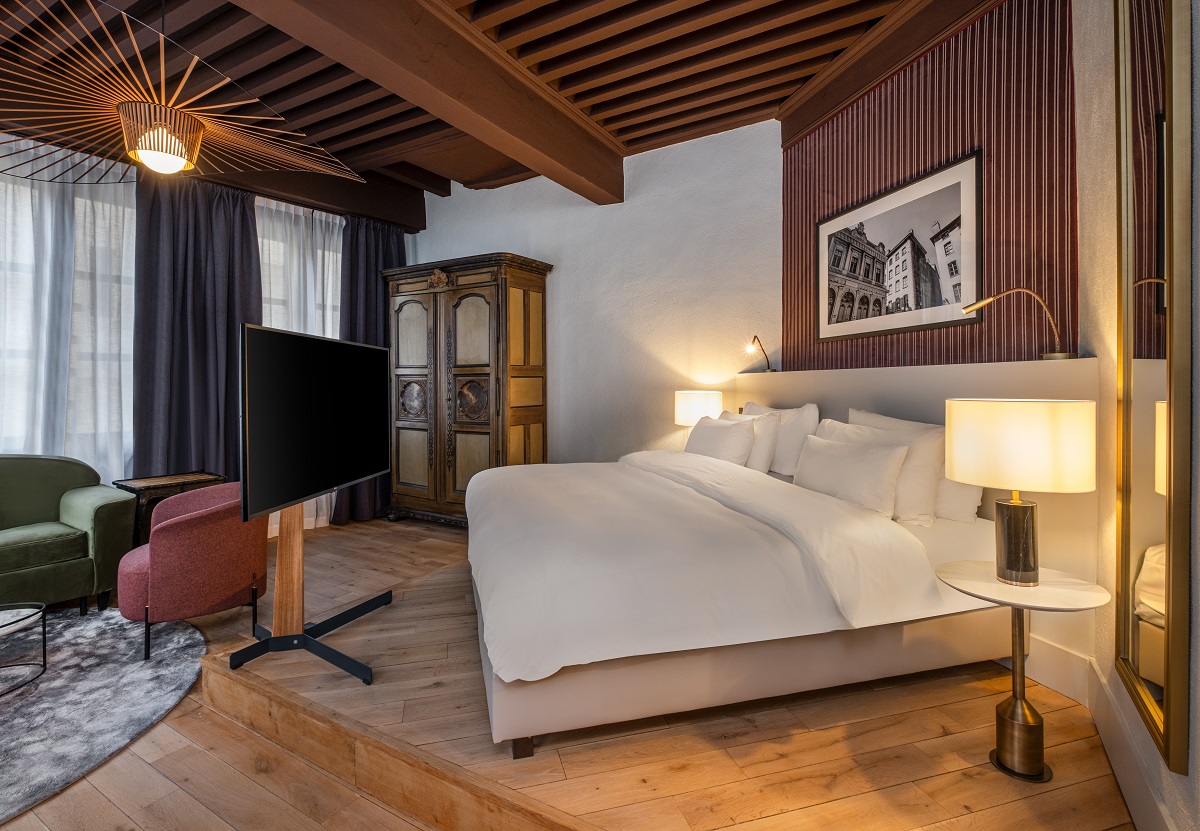 guestroom with period features and wooden beams in Radisson Cour des Loges