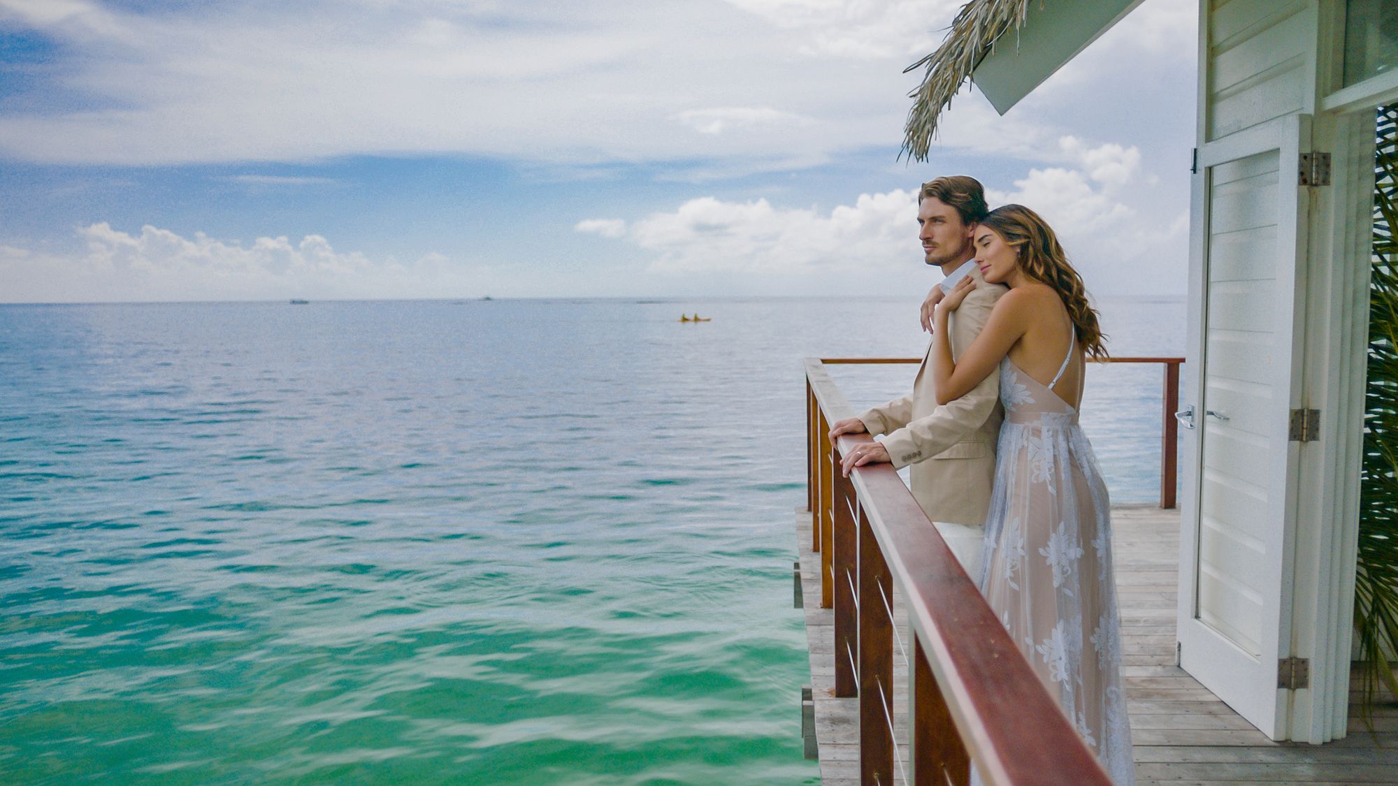 elegant couple looking out to ocean