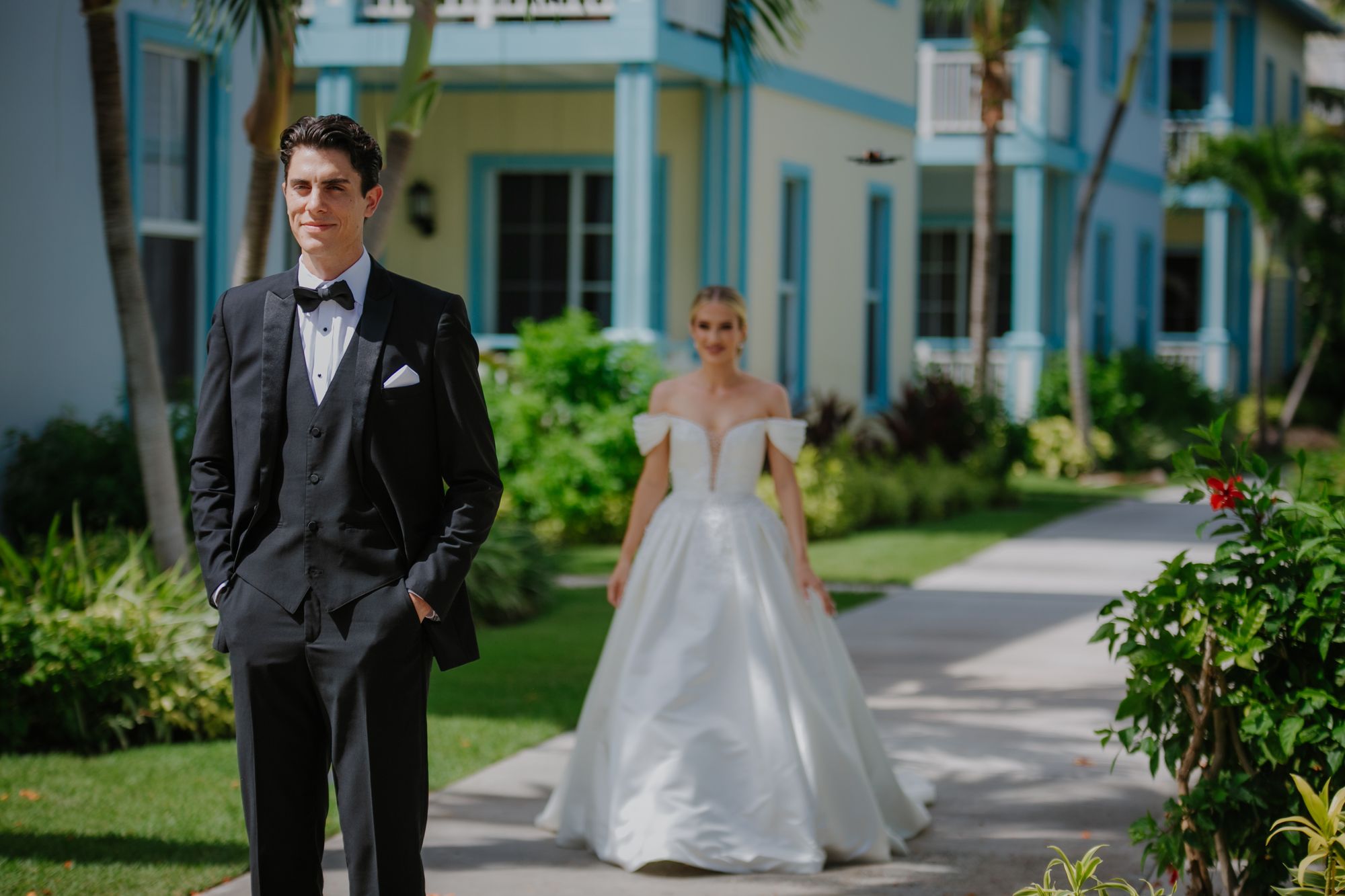 jackson standing facing away from sarah who is approaching him for the first look