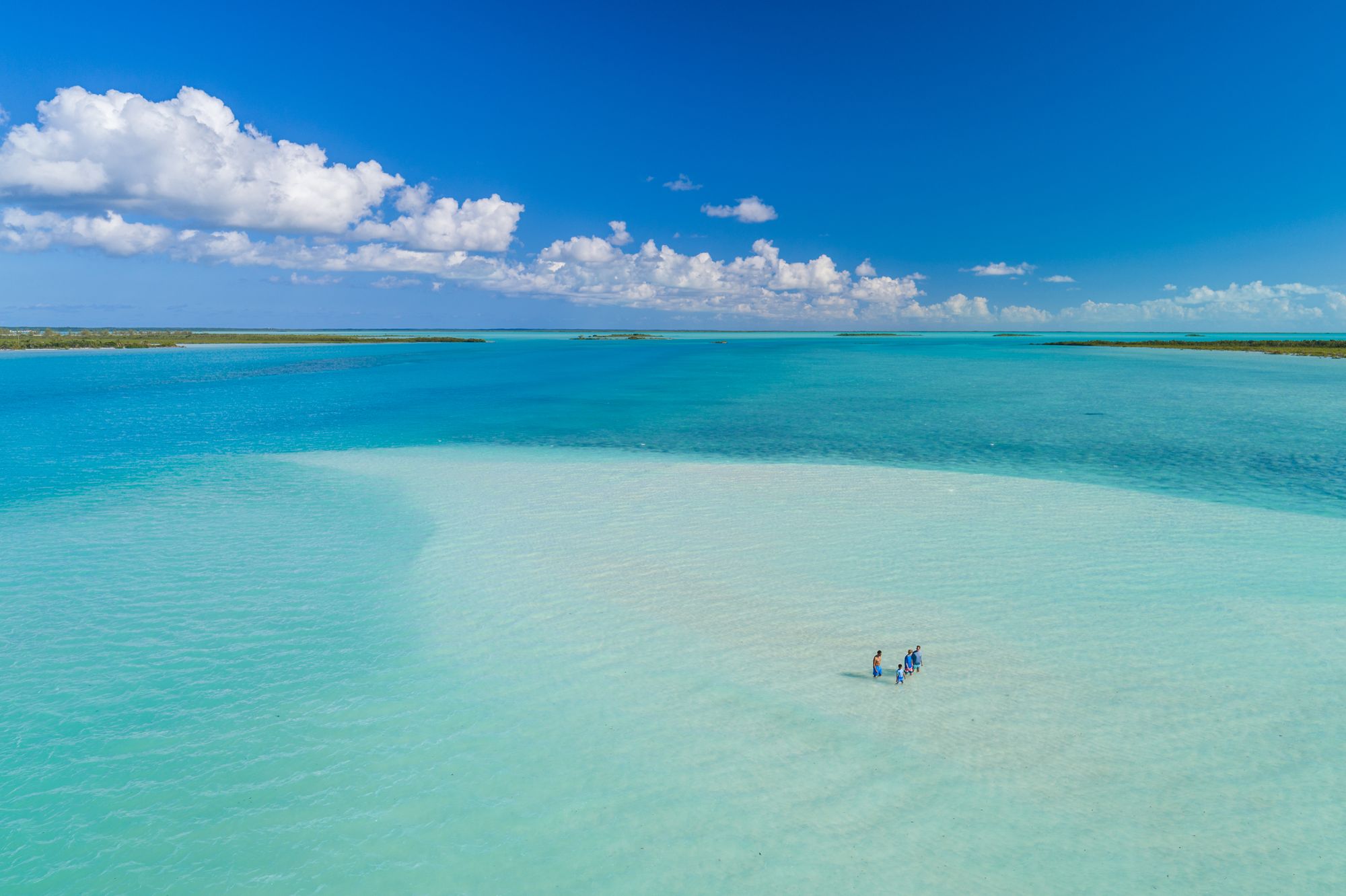 family walking in ocean Turks and Caicos