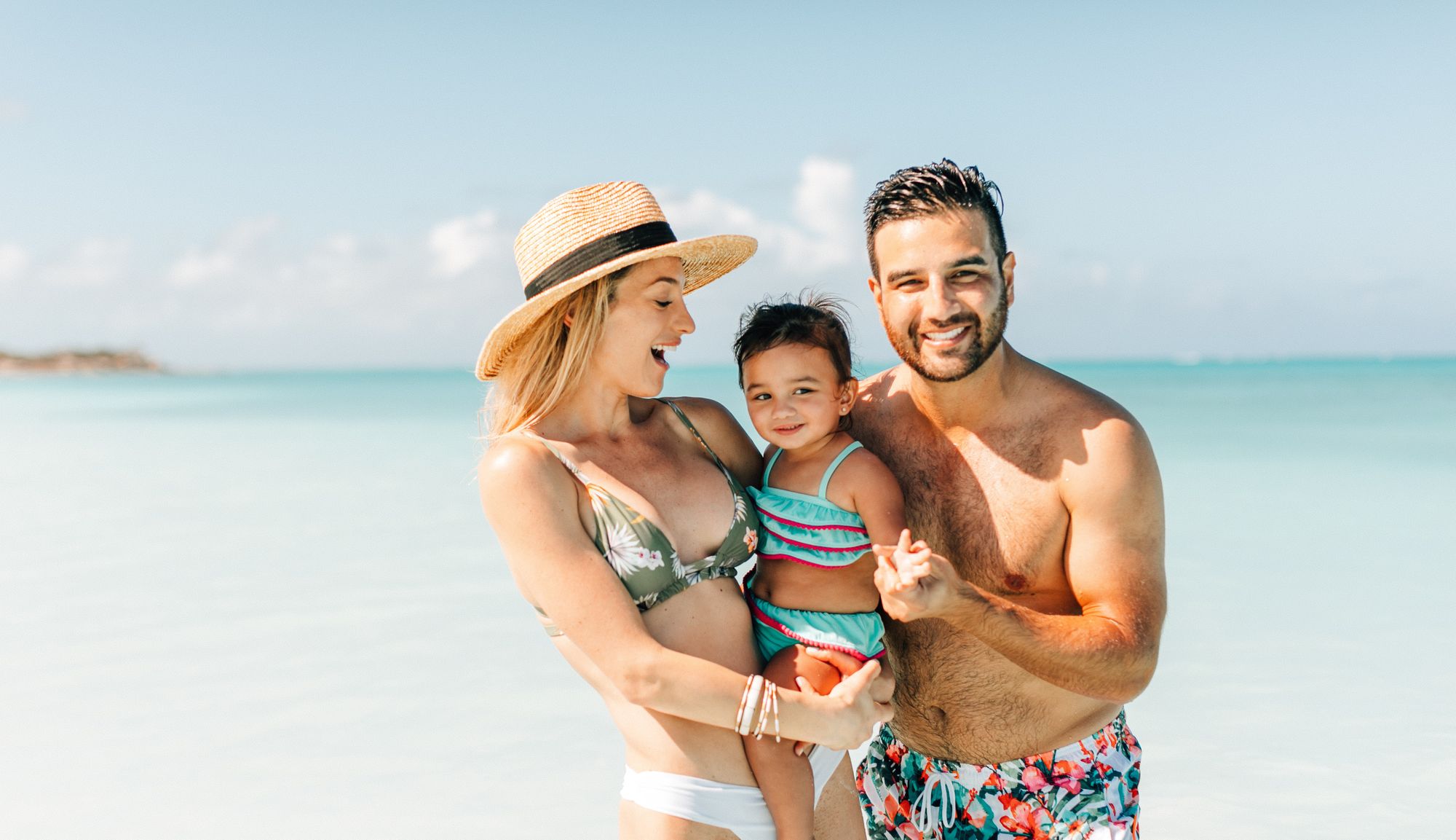 Couple on beach with baby