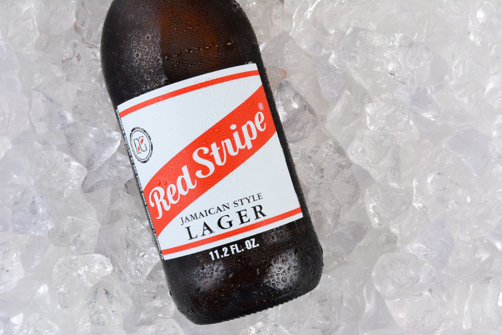 red stripe beer bottle on ice