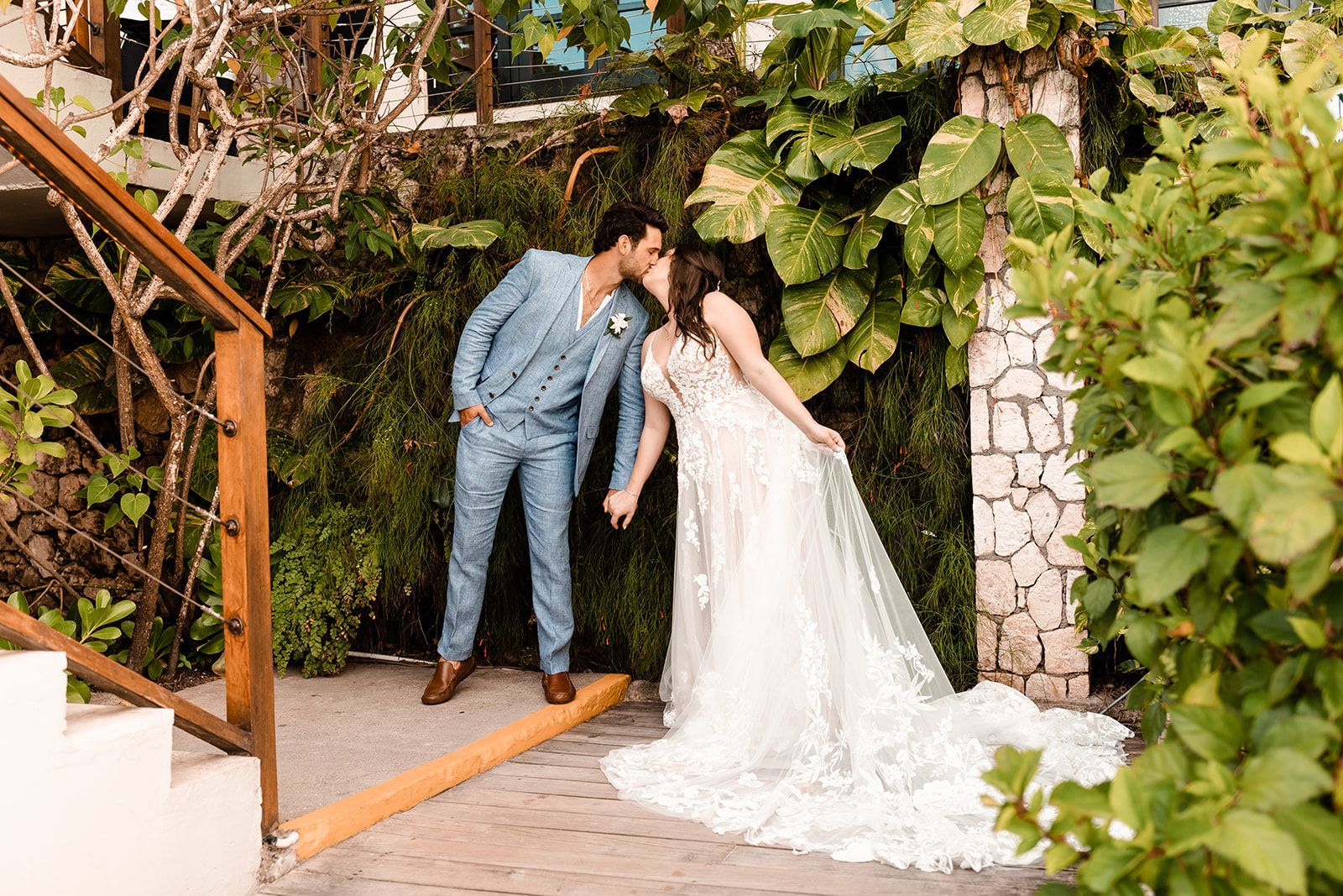 conor and kirsten kissing near a lush backdrop at sandals ochi