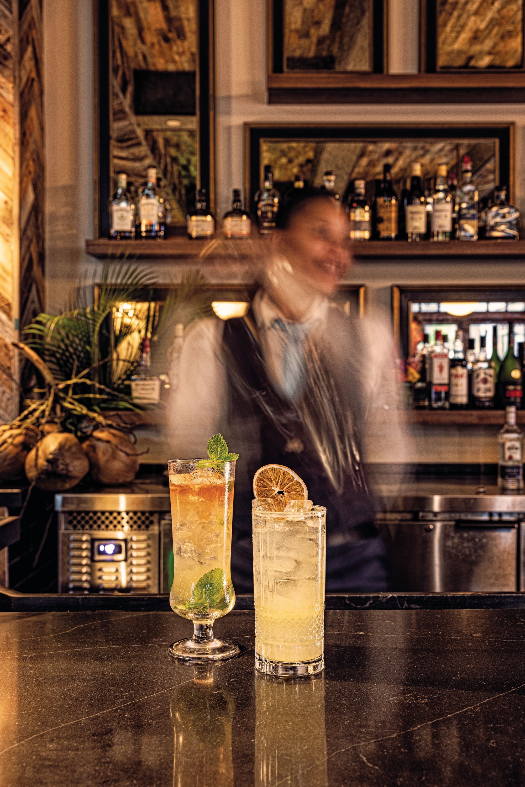 two drinks in focus on a bar countertop